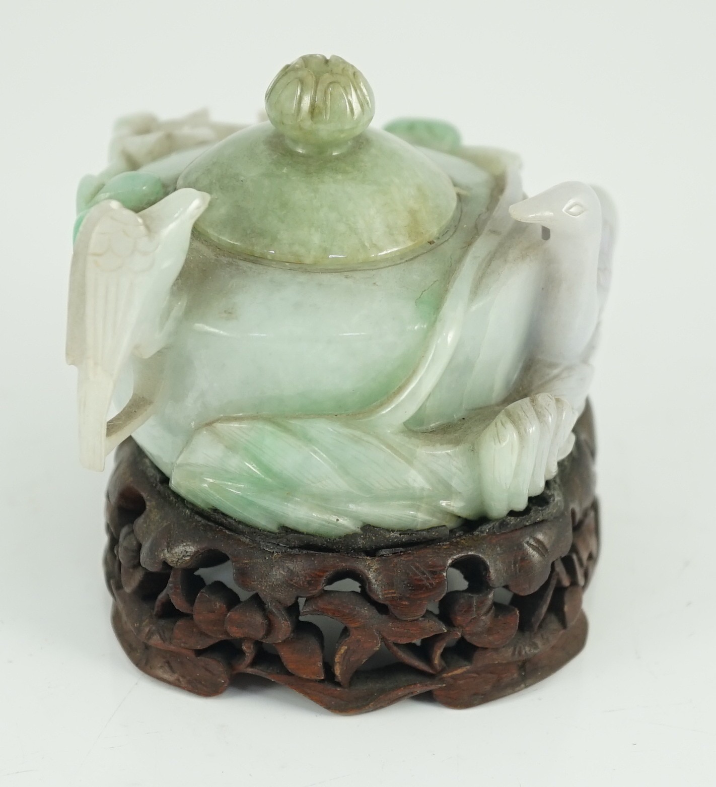 A Chinese lavender and green jadeite water pot and stand, late 19th century, 9.3cm at widest point, wood stand